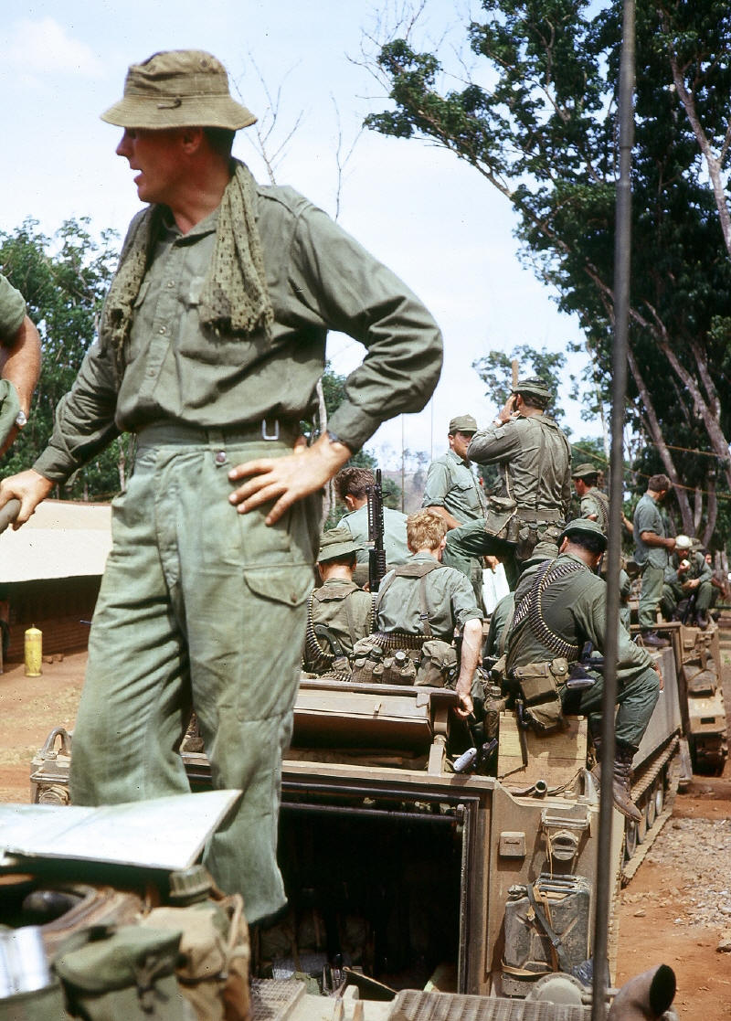 It was common for troops to ride on top of APC - Maj Evan Torrance & Coy HQ mounting APC before departure Nui Dat [Stock]