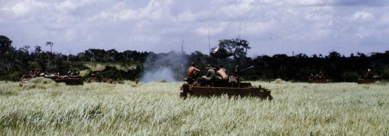 dustoff Op Massey Harris - APC surround the LP where two dustoff are landing assisted by smoke, the crippled APC is left side of group [Lewis]