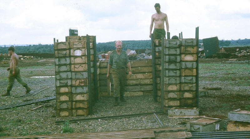 1Pl bunker under construction, old perimeter beyond.  CSM Mackintosh standing in centre of bunker [Stock]