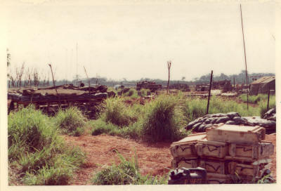 facilities dug into the ground were protected by eath filled empty shell cases, sandbags & steel revetting flown in especially for the defence works     [Young]