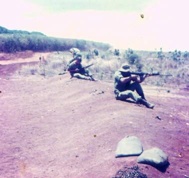 weapon testing & snap shooting practise on the Nui Dat range just outside the perimeter wire [base in trees at rear] [Rowsell]