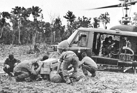 pad party crouching over the MAINTDEM at the end of a resupply while the helicopter gets airborne again [2RAR Journal]