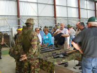 1 RNZIR soldiers show Vietnam war veterans weapons of a type used by the veterans. On the table are 7.62m SLRs, 5.56mm M16s, a 7.62mm, AK47 and an RPG launcher